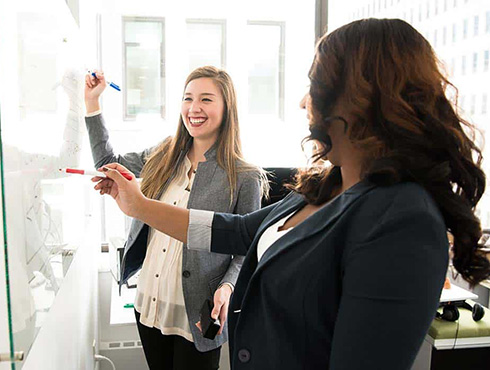 two women at whiteboard