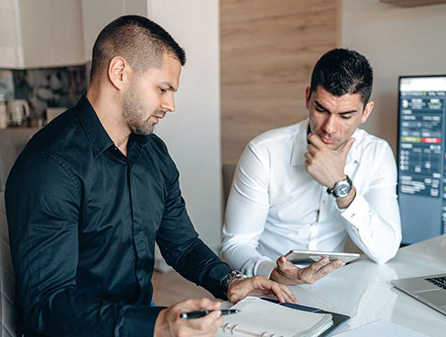 two men studying trends