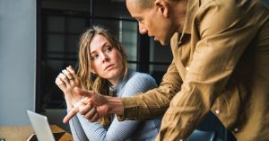 two people talking at laptop