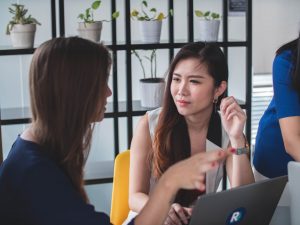 Two workers in a meeting discussing global talent strategy