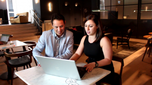 Two workers at laptop in lounge