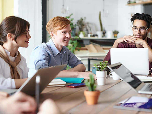 employees sitting around a table in an office