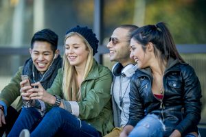 four young people sitting together