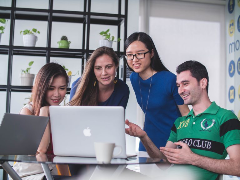 four team members collaborating at table