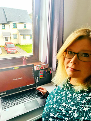 woman working at laptop while on furlough