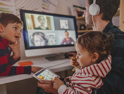 man on virtual meeting holding a child