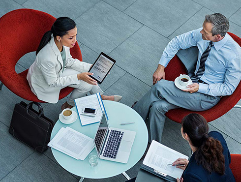 three people sitting around table