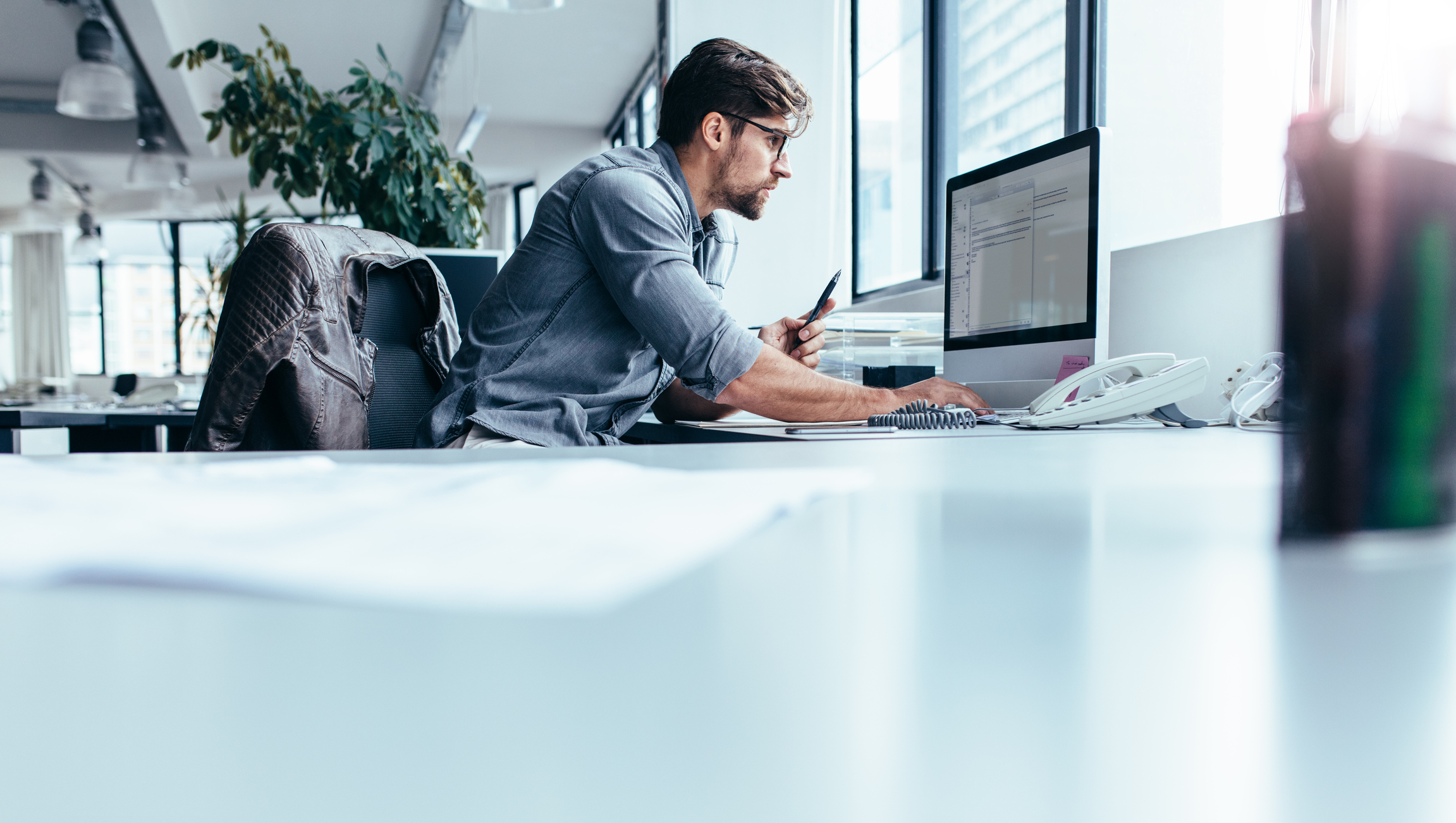 Young businessman in office working on computer