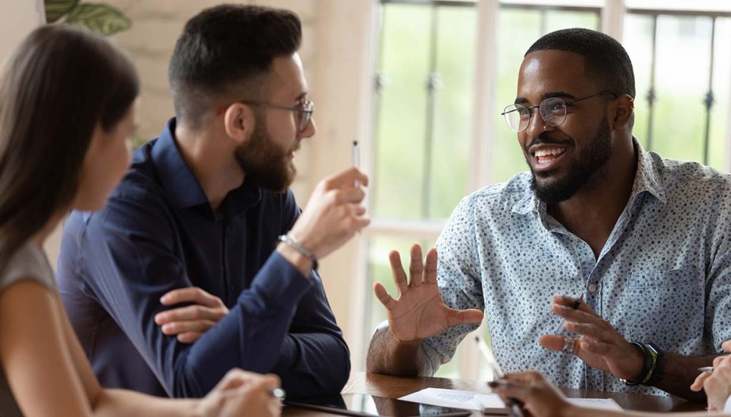 three workers discussing MSP