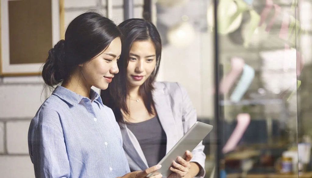 two asian business women working together in office