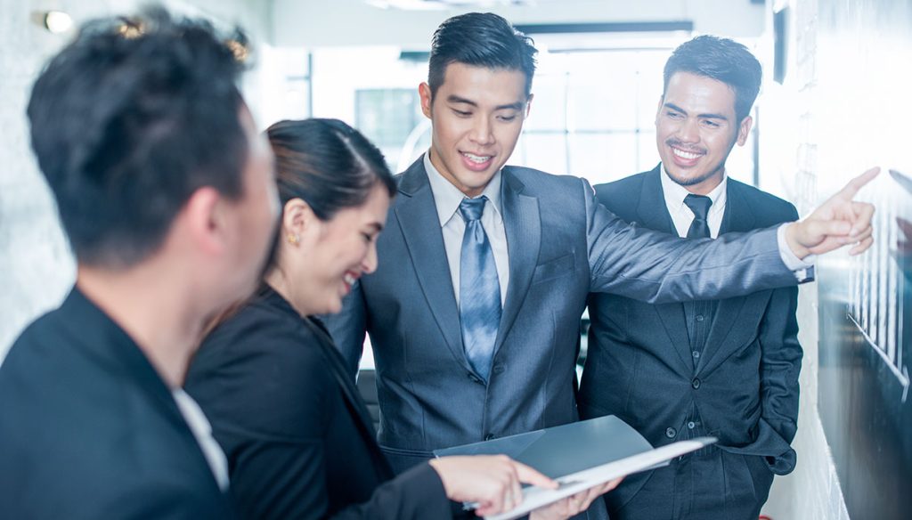 Young Asian business people at work.