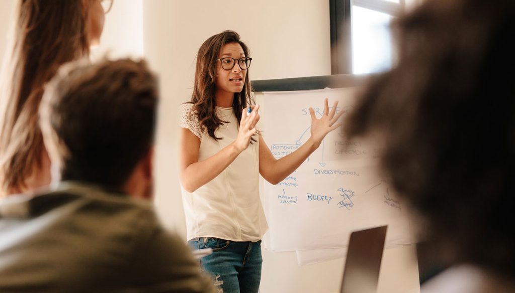 Businesswoman explaining new plan to colleagues in conference room