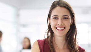 woman smiling with office in background