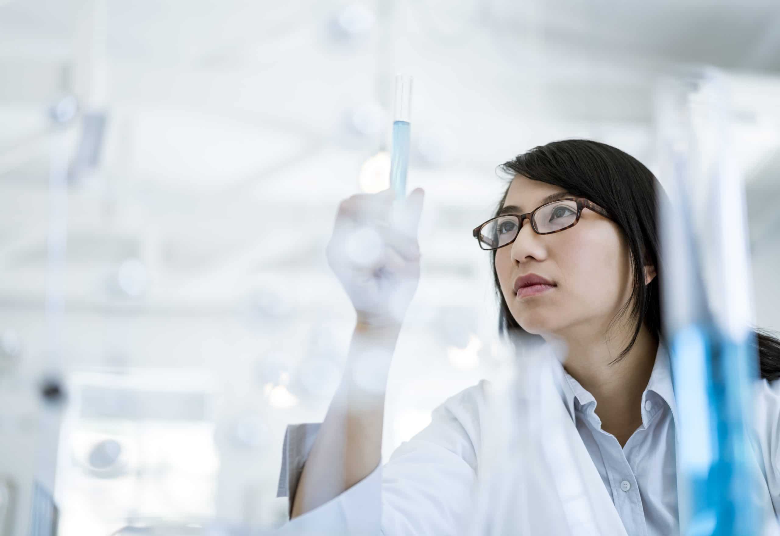 Scientist doctor looking at sample in test tube