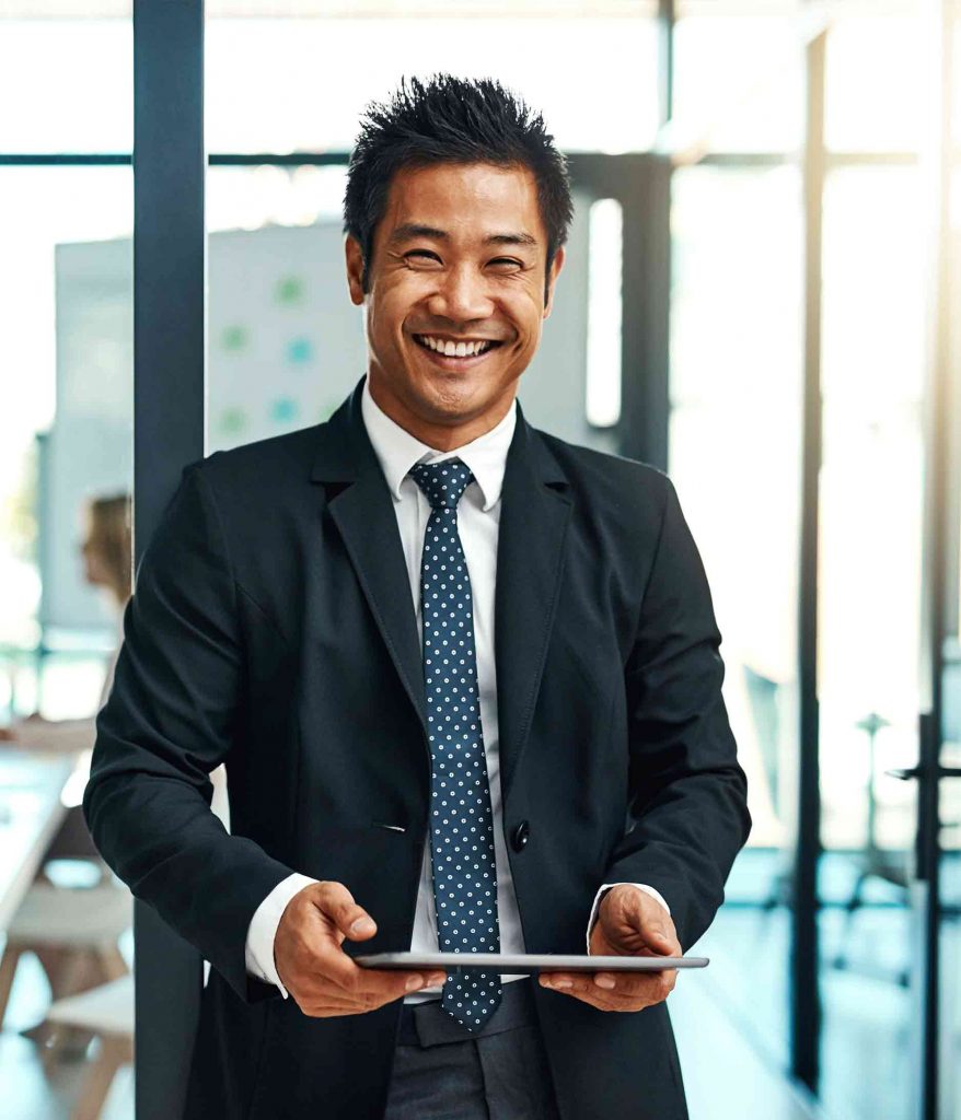 asian man holding tablet in office