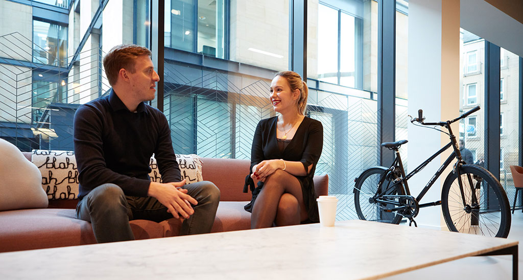 two colleagues in relaxed conversation