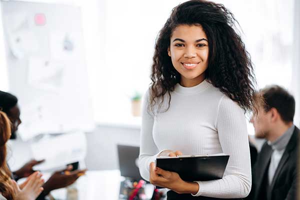 woman in meeting holding a folder