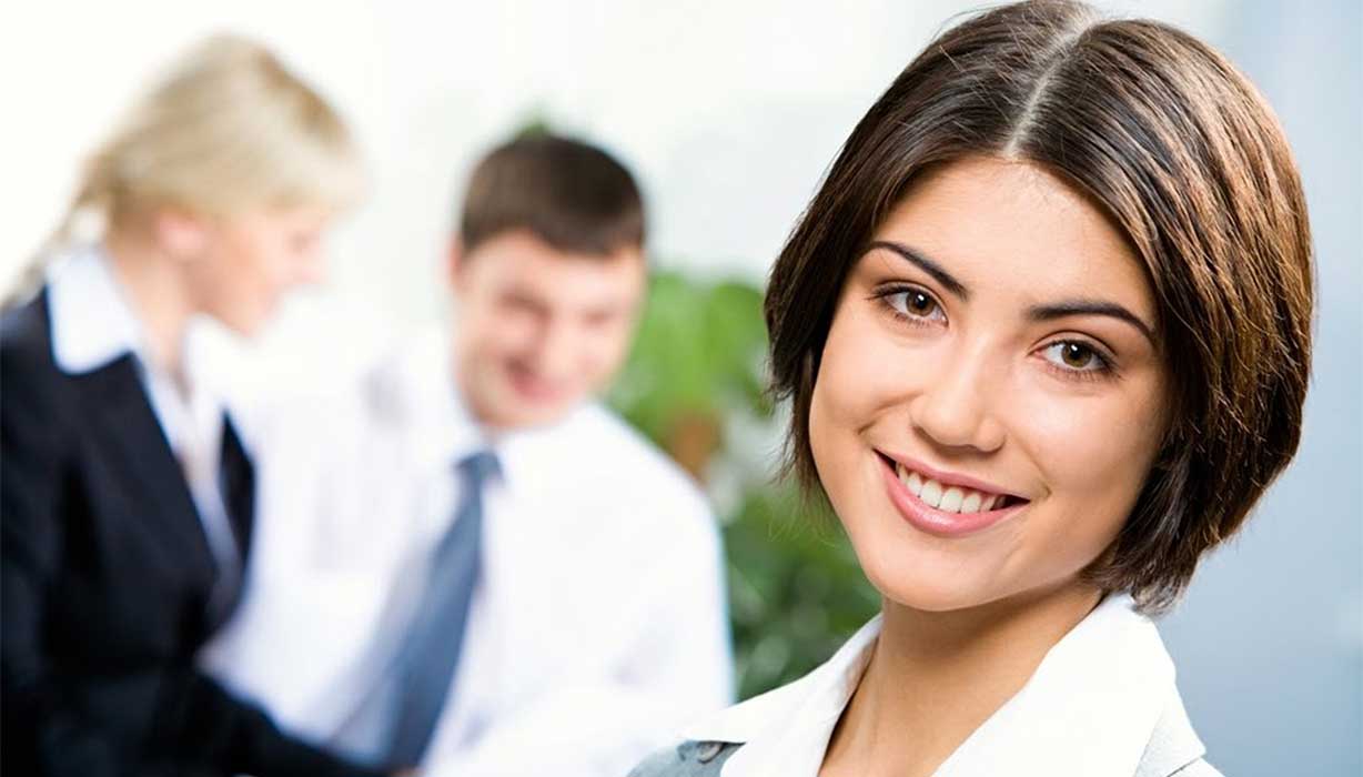 smiling girl with two workers in the background