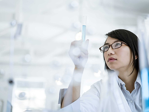 woman observing test tube