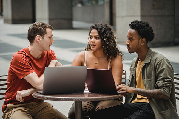 three workers in outdoor meeting