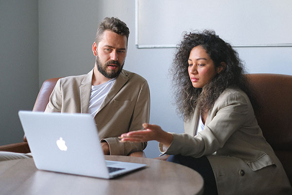 two workers looking at laptop