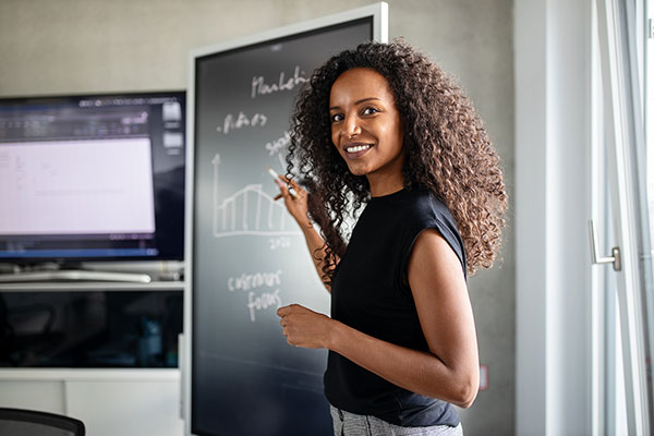 person discussing strategy at blackboard