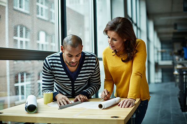 two workers discussing strategy