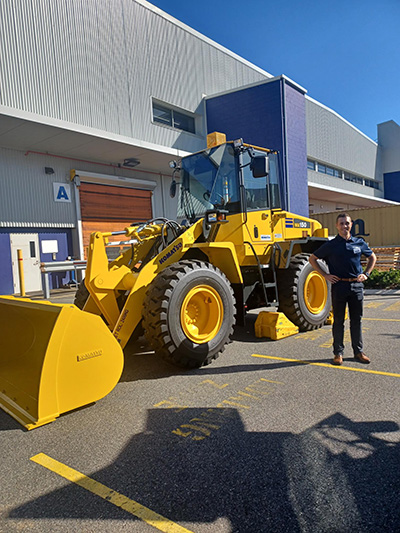 Nathan standing near tractor