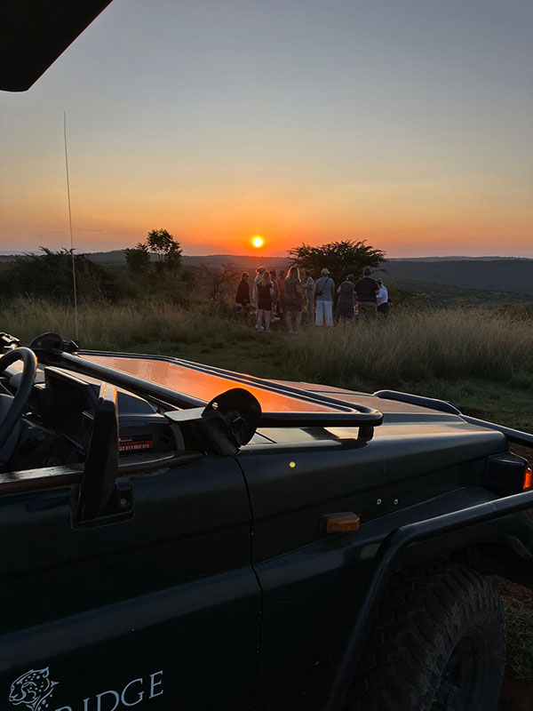 team watching sunset in Africa