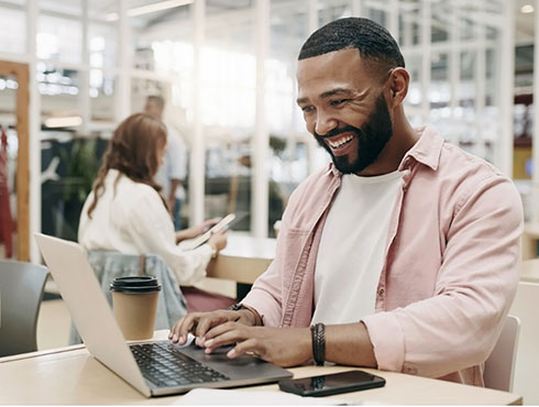 smiling man working at a desk in an office