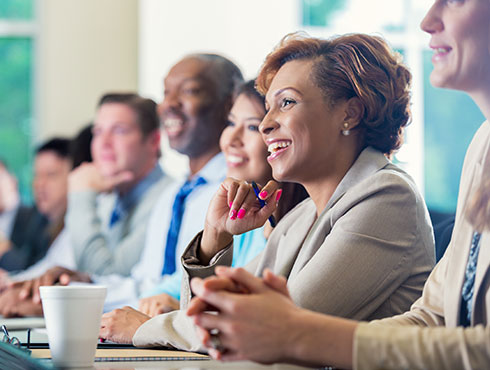 Diverse team listening to conference