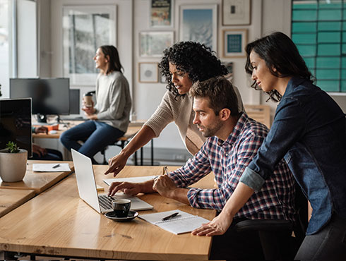 three people working together in an office