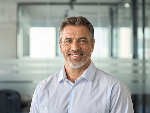 smiling man in white shirt in an office