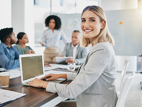 smiling woman in an office sitting at a table