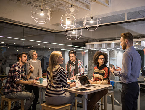 several people sitting in a conference room listening to a presentation