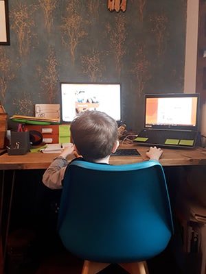 little boy sitting at desk